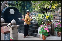 Woman offers incense at Vo Thi Sau grave. Con Dao Islands, Vietnam ( color)
