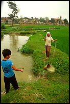Field irrigation with a swinging bucket. Vietnam ( color)