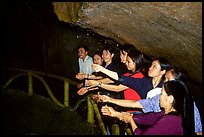 Women catch the water seeping from Tan Thanh Cave, said to have mirculous properties. Lang Son, Northest Vietnam (color)
