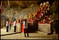 Women praying at the altar at the entrance of Tan Thanh Cave. Lang Son, Northest Vietnam (color)