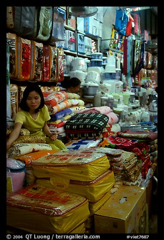 Vendor sitting amongst Abondance of cheap goods imported from nearby China at the Dong Kinh Market. Lang Son, Northest Vietnam