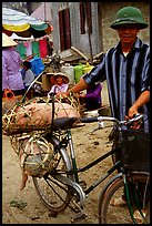 Man with a newly bought pig loaded on his bicycle, That Khe market. Northest Vietnam ( color)