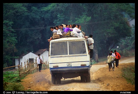 Passengers sitting on top of an overloaded bus. Northest Vietnam