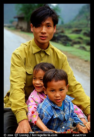 Young man carrying two kids on his bicycle. Northeast Vietnam (color)
