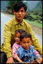 Young man carrying two kids on his bicycle. Northeast Vietnam