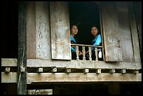 Two thai women at the window of their stilt house, Ban Lac village. Northwest Vietnam
