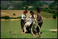 Thai women loading a bicycle, near Tuan Giao. Northwest Vietnam (color)