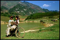 Thai women load a bicycle, near Tuan Giao. Northwest Vietnam (color)