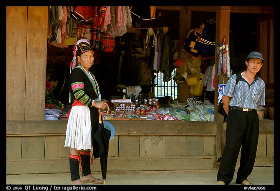 Man and montagnard woman in front of a store, near Lai Chau. Northwest Vietnam (color)