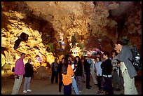 Tourists in illuminated cave. Halong Bay, Vietnam (color)