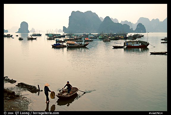 Rowboat meeting woman on shore. Halong Bay, Vietnam (color)