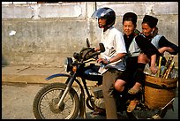 Black Hmong Women riding at the back of a Russian motorbike. Sapa, Vietnam (color)