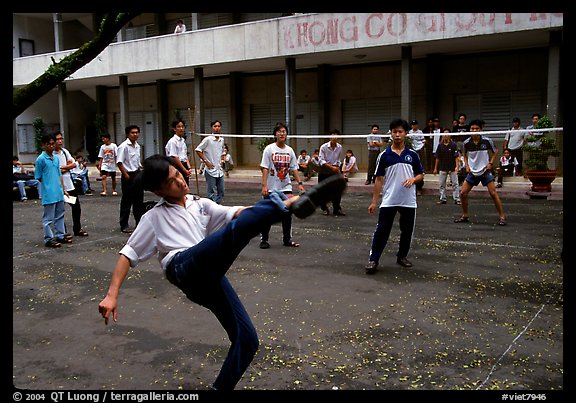 Students playing foot-only volley-ball in a school courtyard. Ho Chi Minh City, Vietnam (color)