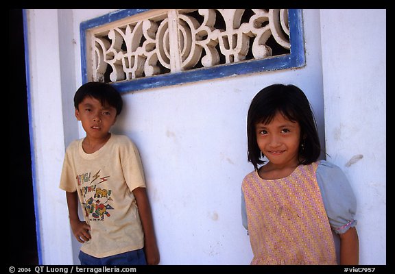 Two kids in front of a wall. Ben Tre, Vietnam