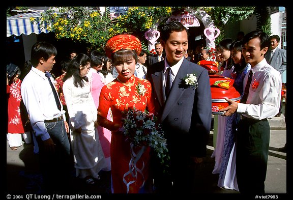 Newly-wed couple exit the bride's home. Ho Chi Minh City, Vietnam (color)