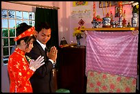Newly-wed couple prays at the groom's ancestral altar. Ho Chi Minh City, Vietnam ( color)