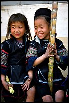 Black Hmong girls, with their daily fix of sugar cane, Sapa. Vietnam (color)