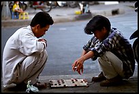 Chinese Chess game. Vietnamese people can sit on their heels for hours. Ho Chi Minh City, Vietnam (color)