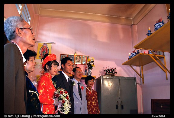 Bride presented to the groom's ancestors in the presence of both parents during a wedding. Ho Chi Minh City, Vietnam (color)