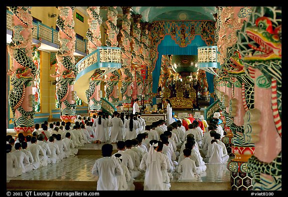 The noon ceremony, attended by priests inside the great Cao Dai temple. Tay Ninh, Vietnam (color)