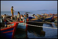 Children play on fishing boats. Vung Tau, Vietnam