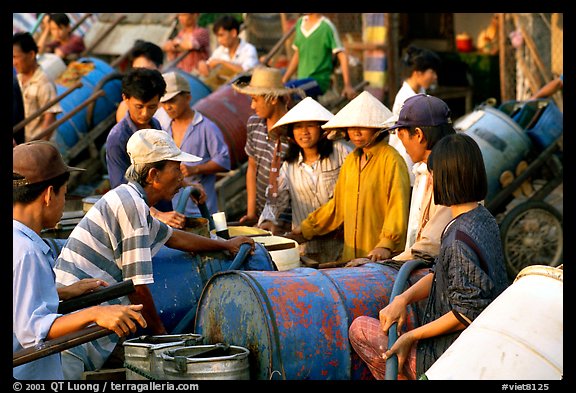 Filling up water tanks for the day. Ha Tien, Vietnam (color)