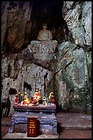Altar and Buddha statue in a troglodyte sanctuary of the Marble Mountains. Da Nang, Vietnam (color)